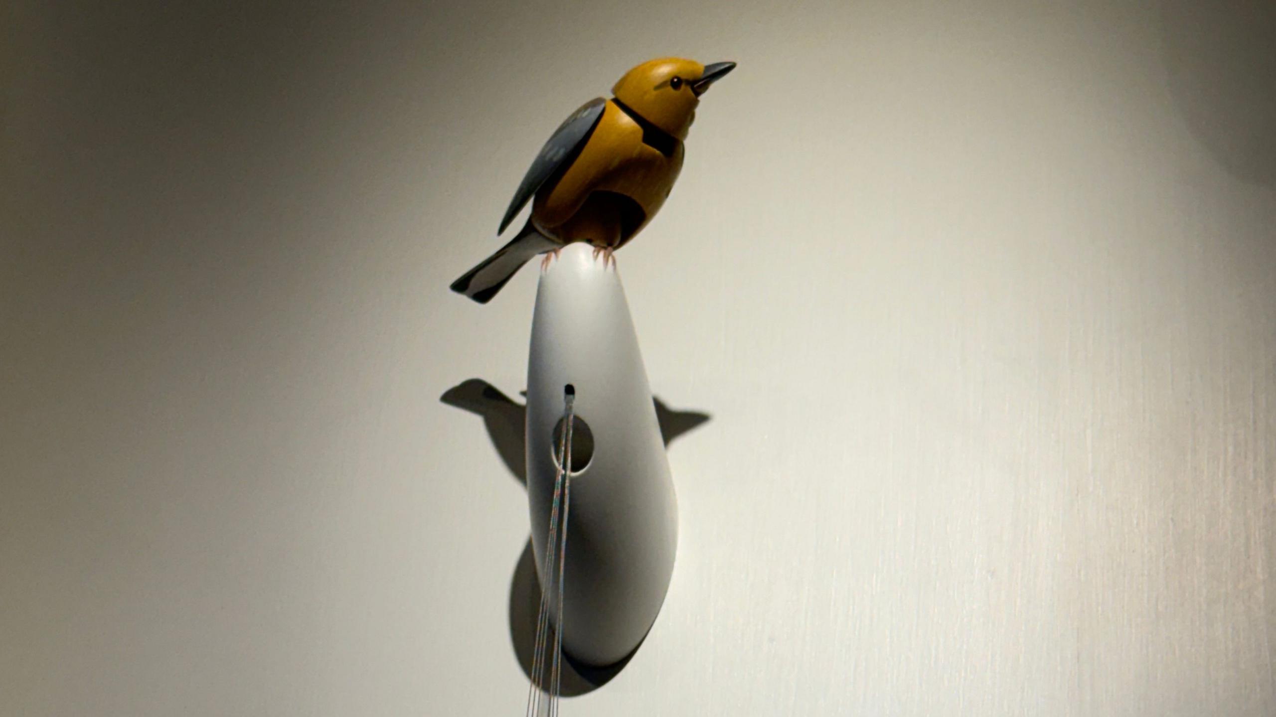 Mechanical bird perched on a wall