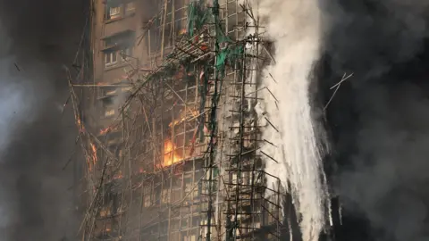 Tragic Blaze in Hong Kong: Firefighters Search for Missing Residents
